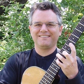 Photo of Mark Anderman holding a guitar